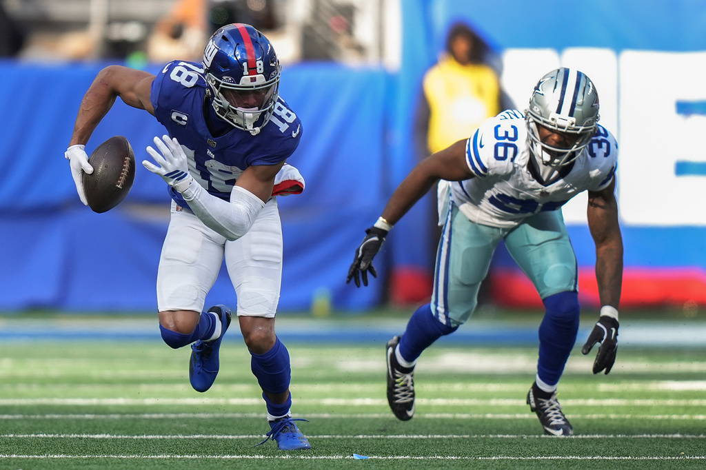 FILE - New York Giants wide receiver Darius Slayton (18) carries the ball against Dallas Cowboys cornerback Corey Ballentine (36) during the second quarter of an NFL football game, Sunday, Jan. 4, 2026, in East Rutherford, N.J. (AP Photo/Frank Franklin II, File)