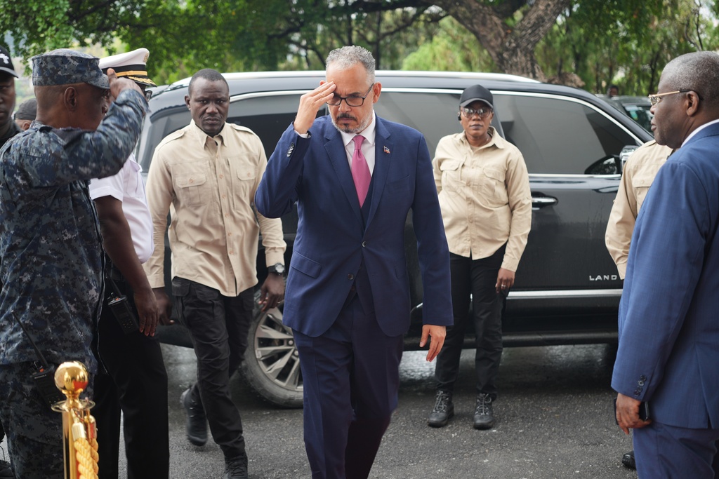 Haitian Prime Minister Alix Didier Fils-Aimé, center, salutes as he arrives for a ceremony marking the end of the presidential council in Port-au-Prince, Haiti, Saturday, Feb. 7, 2026. (AP Photo/Odelyn Joseph)
