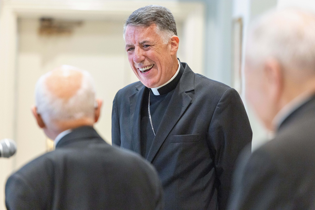 Former Archbishop of New Orleans Alfred Hughes, left, and Archbishop of New Orleans Gregory Aymond, right, look at the Most Rev. Fr. James F. Checchio, center, at Checchio's introduction as the next Archbishop of New Orleans on Wednesday, Sept. 24, 2025, in New Orleans. (Chris Granger/The Times-Picayune/The New Orleans Advocate via AP)