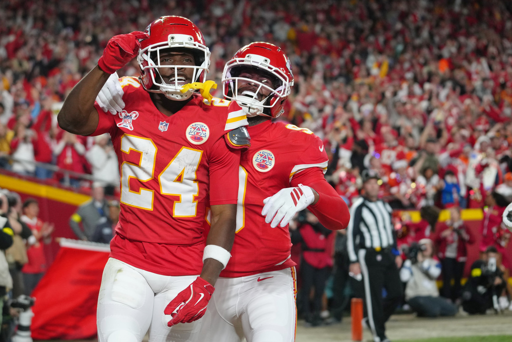 Kansas City Chiefs running back Brashard Smith (24) celebrates with wide receiver Juju Smith-Schuster after scoring a touchdown against the Denver Broncos during the first half of an NFL football game Thursday, Dec. 25, 2025, in Kansas City, Mo. (AP Photo/Ed Zurga)