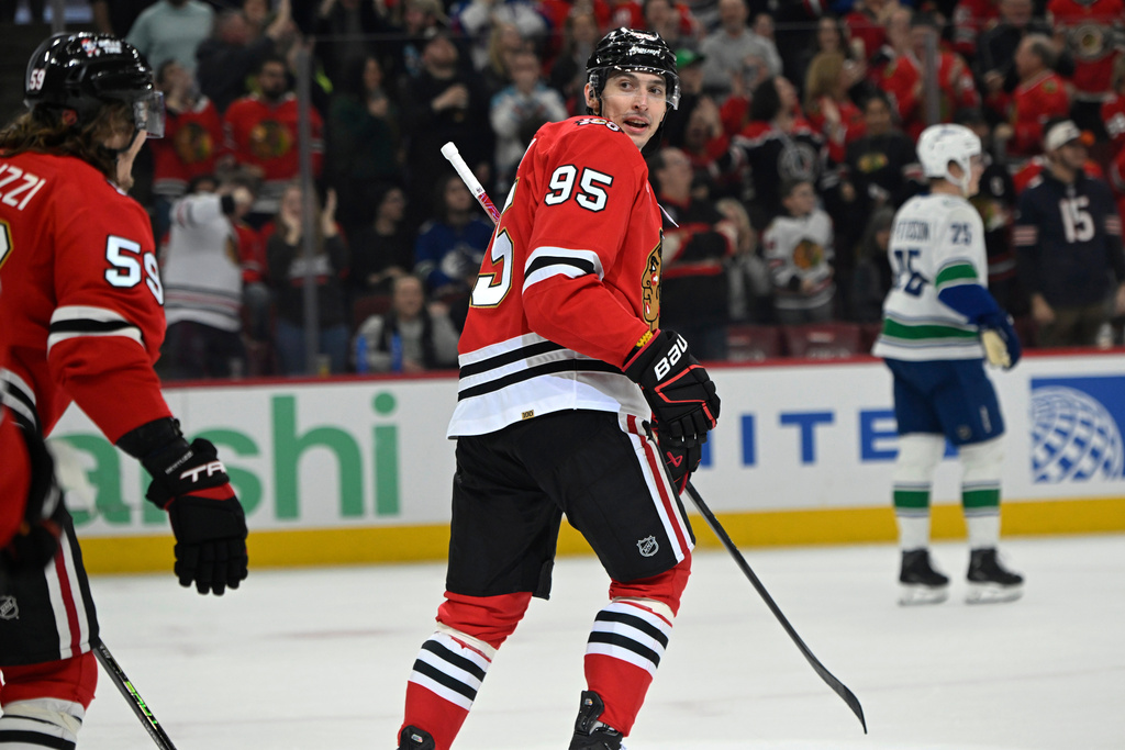 Chicago Blackhawks' Ilya Mikheyev (95) celebrates with teammates after scoring a goal during the first period of an NHL hockey game against the Vancouver Canucks in Chicago, Friday, March 6, 2026. (AP Photo/Paul Beaty)