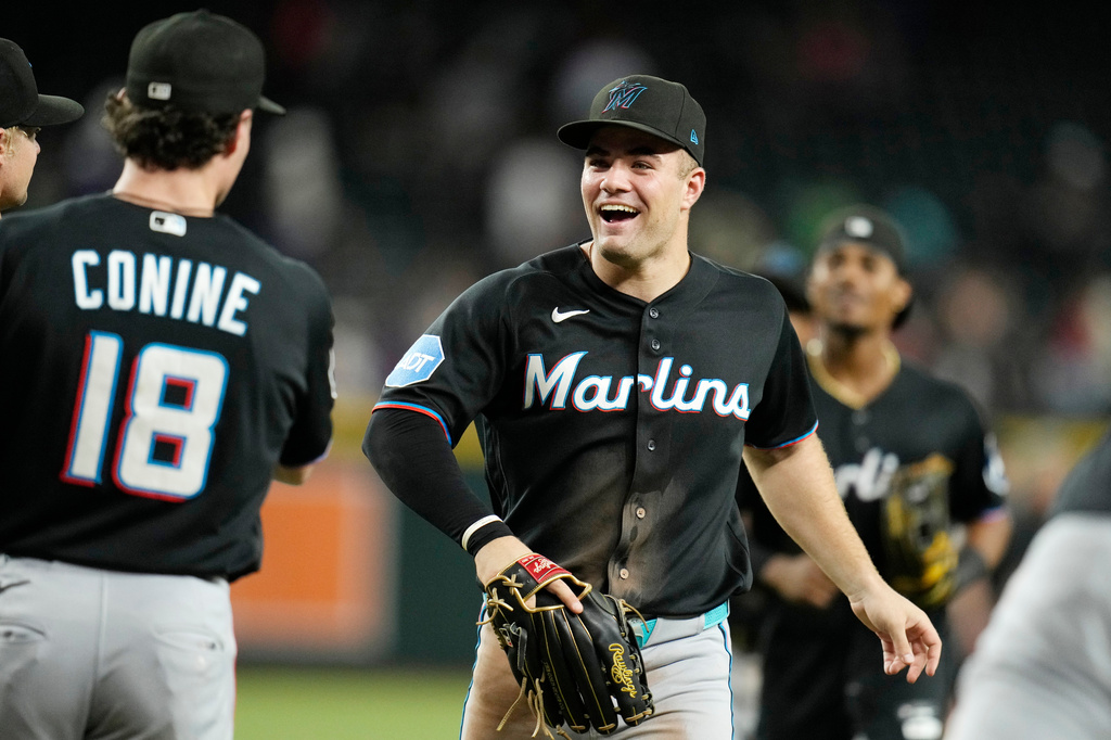 Miami Marlins' Jakob Marsee, right, celebrates a win against the Arizona Diamondbacks with Marlins' Griffin Conine (18) after a baseball game, Wednesday, Sept. 16, 2026, in Phoenix. (AP Photo/Ross D. Franklin)