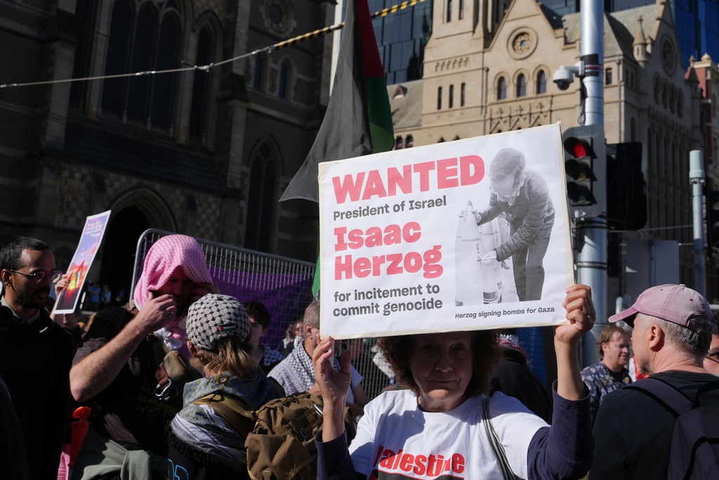 Demonstrators gather in Melbourne, Thursday, Feb. 12, 2026, to protest the visit to Australia by Israeli President Isaac Herzog. (AP Photo/Asanka Brendon Ratnayake)