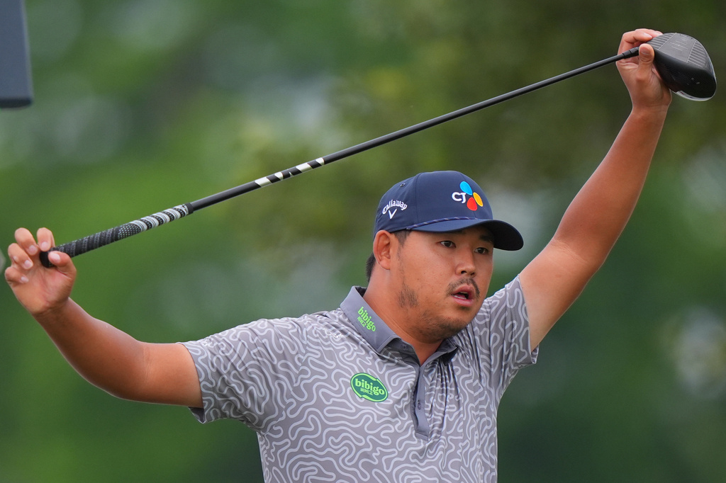 Si Woo Kim, of South Korea, stretches before his tee shot on the 11th hole during the first round of the Byron Nelson golf tournament in McKinney, Texas, Thursday, May 21, 2026. (AP Photo/LM Otero)