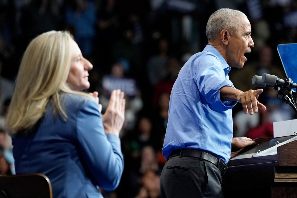 Former President Barack Obama, gestures during a rally for Virginia Democratic gubernatorial candidate Abigail Spanberger, left, Saturday, Nov. 1, 2025, in Norfolk, Va. (AP Photo/Steve Helber)