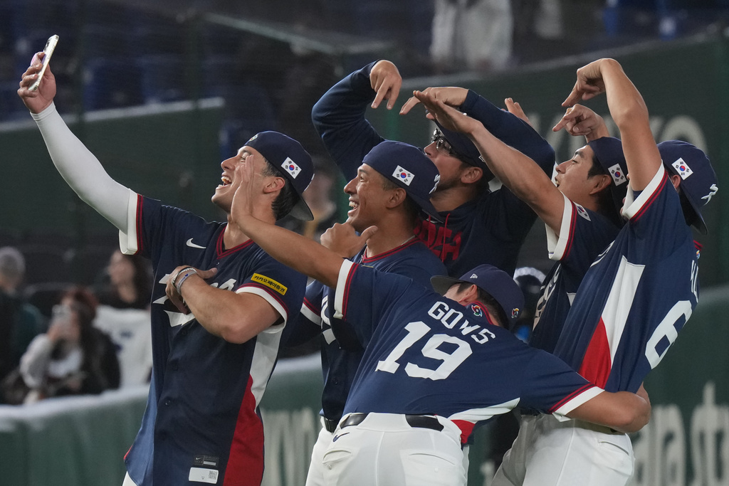 South Korea players take a selfie as they celebrate after defeating Australia in their World Baseball Classic game on Monday, March 9, 2026 in Tokyo. (AP Photo/Eugene Hoshiko)