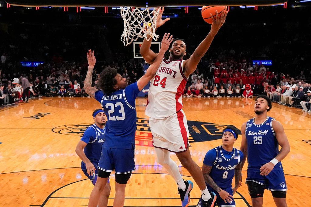 St. John's forward Zuby Ejiofor (24) shoots over Seton Hall guard Mike Williams III (23) during the first half of an NCAA college basketball game in the semifinals of the Big East tournament, Friday, March 13, 2026, in New York. (AP Photo/Yuki Iwamura)