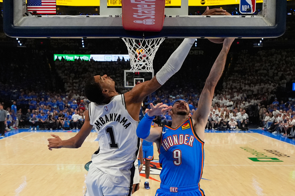 San Antonio Spurs forward Victor Wembanyama (1) blocks a shot by Oklahoma City Thunder guard Alex Caruso (9) during the second half of Game 2 in the Western Conference finals NBA basketball playoffs series Wednesday, May 20, 2026, in Oklahoma City. (AP Photo/Nate Billings)