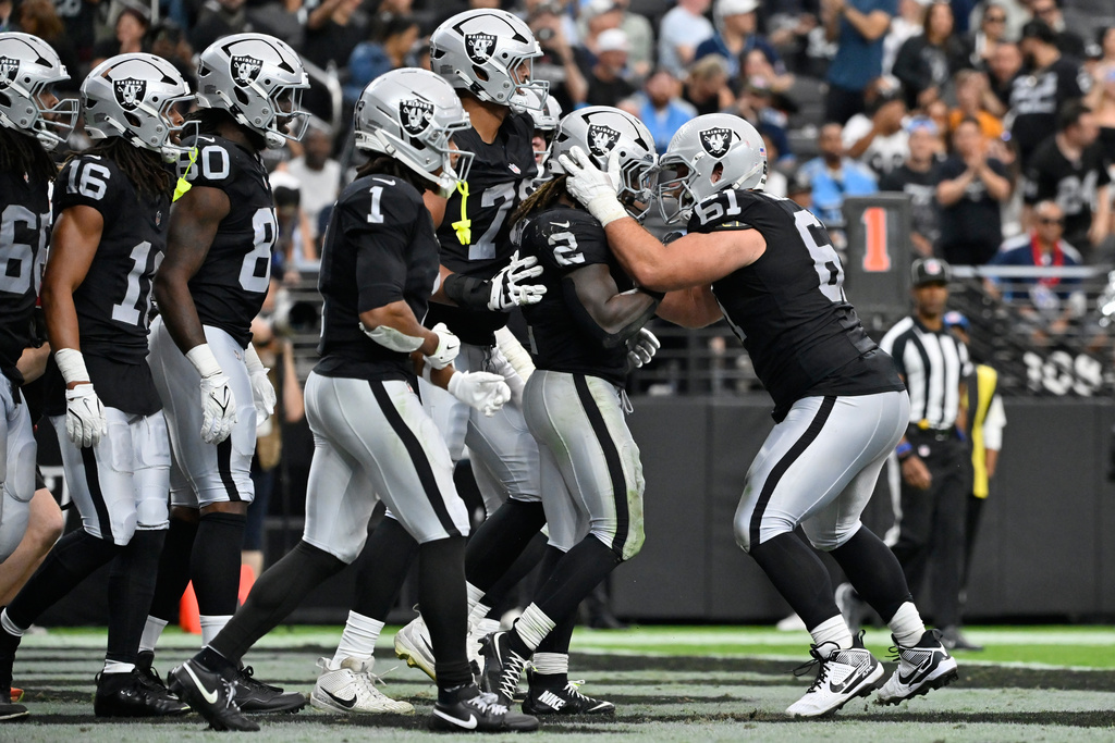 Las Vegas Raiders guard Jordan Meredith (61) celebrates after Las Vegas Raiders running back Ashton Jeanty (2) scored a touchdown against the Tennessee Titans during the second half of an NFL football game, Sunday, Oct. 12, 2025, in Las Vegas. (AP Photo/David Becker)