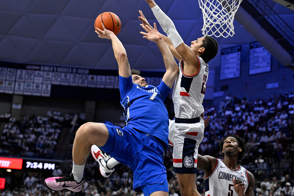 Creighton guard Fedor Žugić (7) makes a basket against UConn forward Jayden Ross (23) in the first half of an NCAA college basketball game, Wednesday, Feb. 18, 2026, in Storrs, Conn. (AP Photo/Jessica Hill)