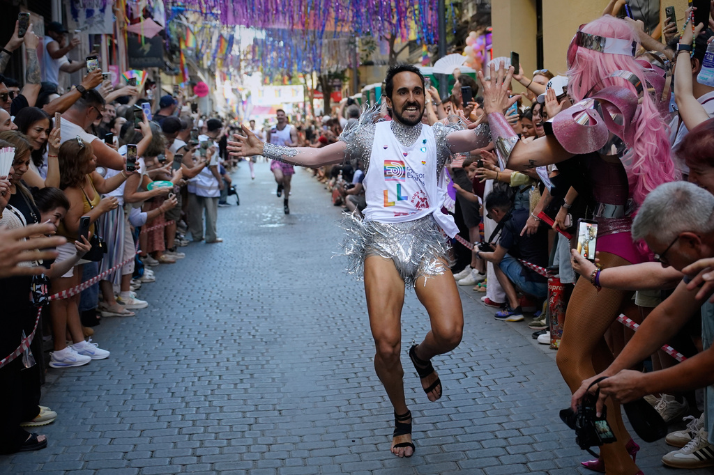 Participants wearing shoes with heels of at least 10 centimeters (3.9 inches) run in the annual high heel race during Madrid's Pride week, in Madrid, Thursday, July 2, 2026. (AP Photo/Andrea Comas)