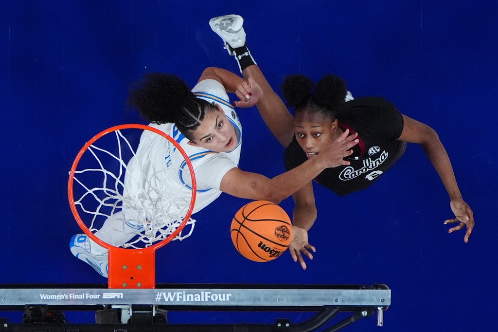 South Carolina forward Joyce Edwards (8) shoots around UCLA center Lauren Betts (51) during the second half of the women's National Championship Final Four NCAA college basketball tournament game, Sunday, April 5, 2026, in Phoenix. (AP Photo/Ross D. Franklin)