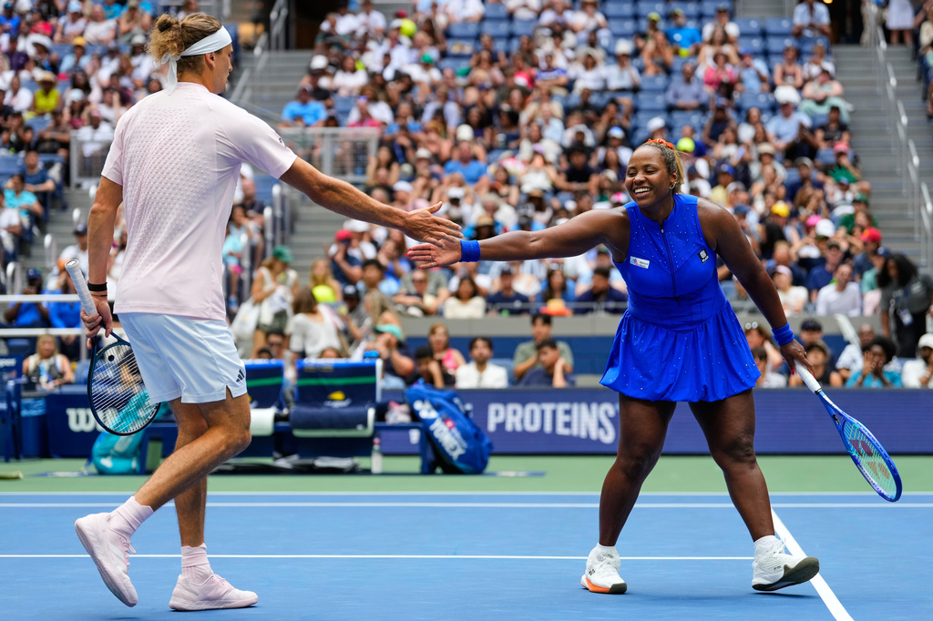 Alexander Zverev, of Germany, left, and Taylor Townsend, of the United States, high-five during a mixed doubles match at the U.S. Open tennis championships, Tuesday, Aug. 25, 2026, in New York. (AP Photo/Yuki Iwamura)
