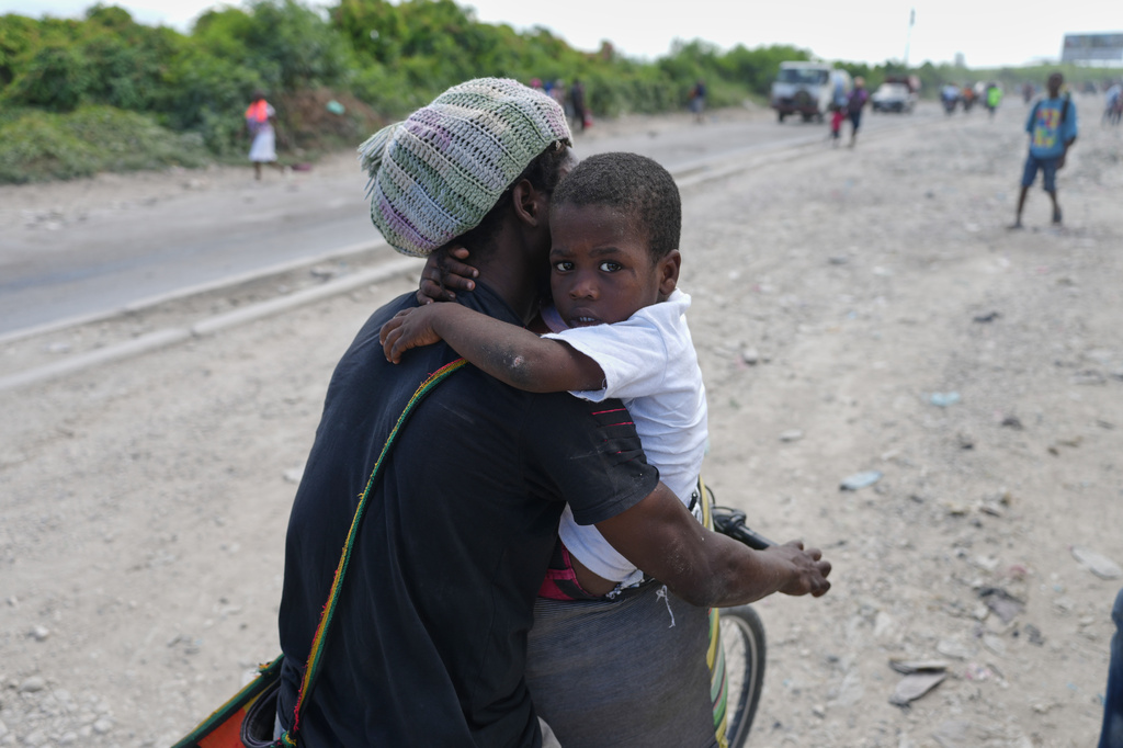 Residents flee their homes to escape clashes between armed gangs in Port-au-Prince, Haiti, Monday, May 11, 2026. (AP Photo/Odelyn Joseph)