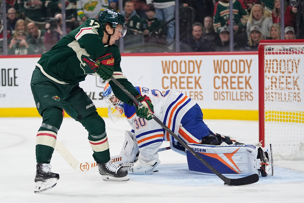 Minnesota Wild left wing Matt Boldy (12) shoots and scores a goal past Edmonton Oilers goaltender Calvin Pickard (30) during the first period of an NHL hockey game, Saturday, Dec. 20, 2025, in St. Paul, Minn. (AP Photo/Abbie Parr)