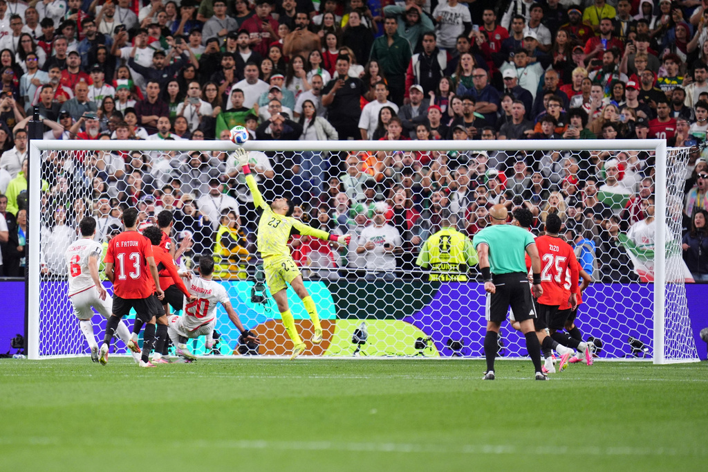 Egypt goalkeeper Mostafa Shoubir (23) jumps to save a shot at goal during the World Cup Group G soccer match between Egypt and Iran in Seattle, Friday, June 26, 2026. (AP Photo/Manu Fernandez)