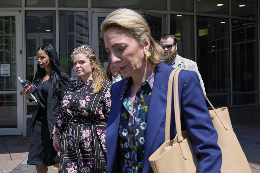 Colin Hortman, behind, son of Melissa and Mark Hortman, and his wife Alina Bachman Hortman, second from left, leave after attending the initial state court appearance for Vance Boelter, Monday, Aug. 3, 2026, in Minneapolis. (AP Photo/Ellen Schmidt)
