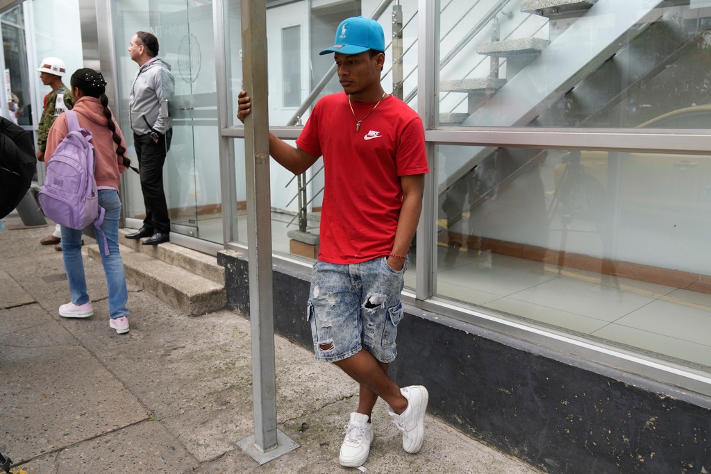 Yeferson de la Hoz, the cousin of soldier Mauro Penaranda who was on the cargo plane that crashed the previous day after take off in Puerto Leguizamo, stands at the military hospital where his cousin is being treated in Bogota, Colombia, Tuesday, March 24, 2026. (AP Photo/Fernando Vergara)