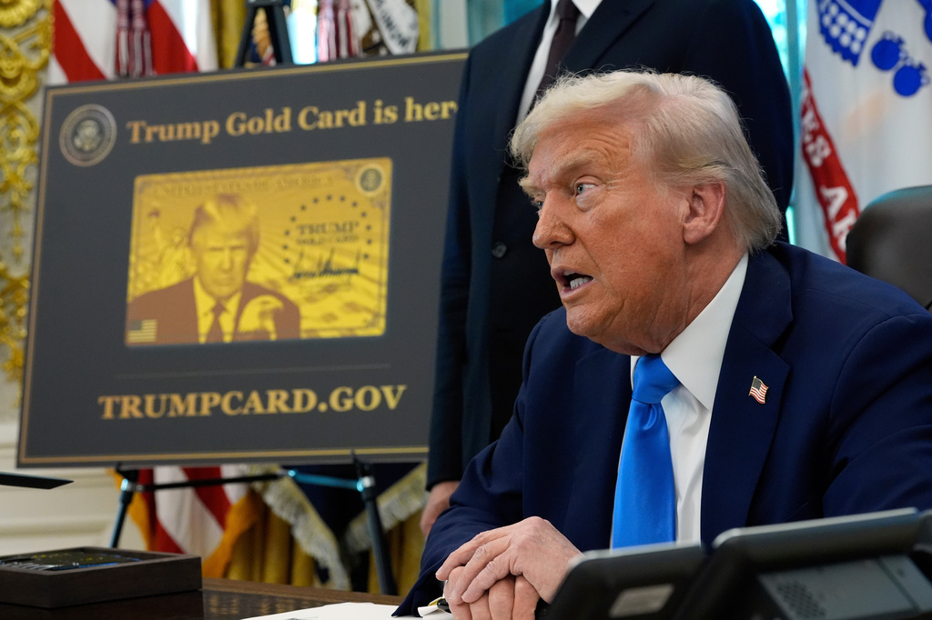 FILE - A poster showing the Trump Gold Card is seen as President Donald Trump signs executive orders in the Oval Office of the White House, Sept. 19, 2025, in Washington. (AP Photo/Alex Brandon, File)