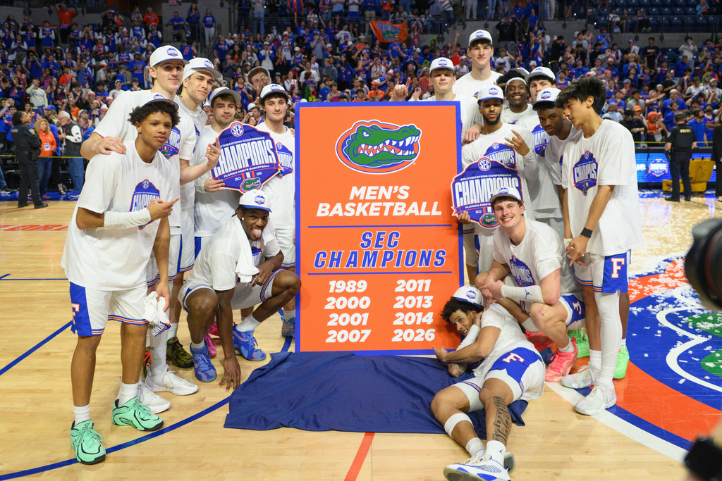 Florida players celebrate after their SEC regular season title after an NCAA college basketball game against Arkansas, Saturday, Feb. 28, 2026, in Gainesville, Fla. (AP Photo/Noah Lantor)