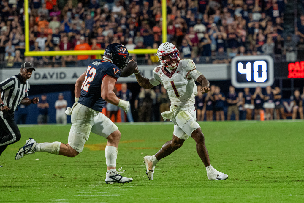 Florida State quarterback Tommy Castellanos (1) throws the ball for a touchdown against Virginia during the second half of an NCAA college football game, Friday, Sept. 26 2025, in Charlottesville, Va. (AP Photo/Robert Simmons)