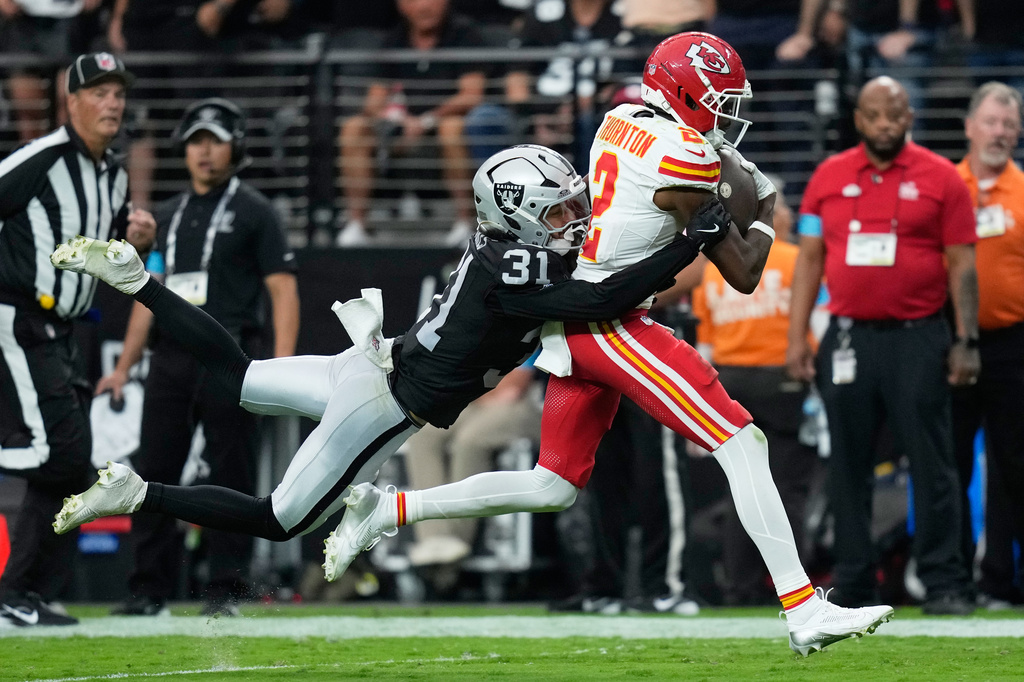 Las Vegas Raiders safety Treydan Stukes (31) tackles Kansas City Chiefs wide receiver Tyquan Thornton (2) during the second half of an NFL football game in Las Vegas, Sunday, Oct. 4, 2026. (AP Photo/John Locher)