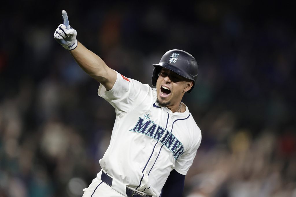 Seattle Mariners' Leo Rivas celebrates his two RBI walk-off home run off St. Louis Cardinals pitcher Ryan Fernandez during the 13th inning in a baseball game Wednesday, Sept. 10, 2025, in Seattle. (AP Photo/John Froschauer)