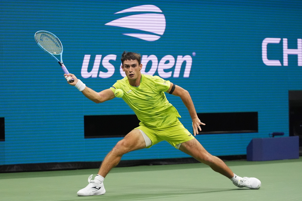 Mariano Navone, of Argentina, returns the ball to Novak Djokovic, of Serbia, during the first round of the U.S. Open tennis championships Sunday, Aug. 30, 2026, in New York. (AP Photo/Frank Franklin II)