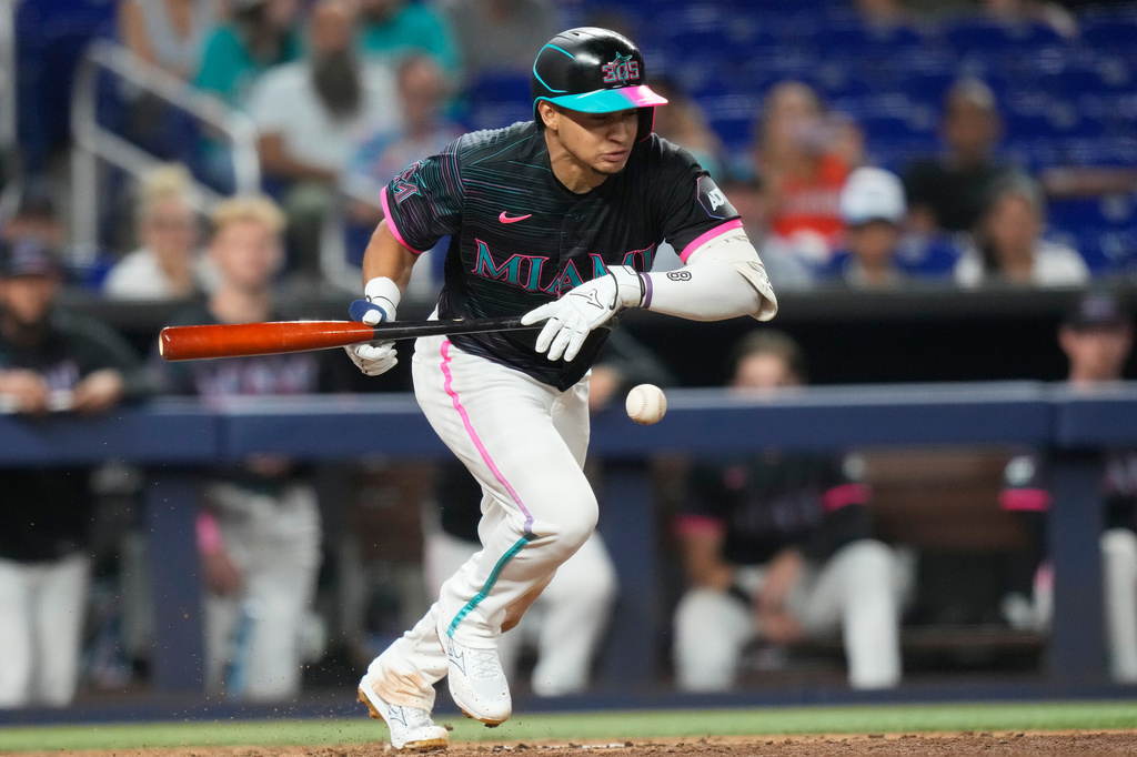 Miami Marlins' Javier Sanoja hits a bunt single during the seventh inning of a baseball game against the San Francisco Giants, Friday, June 19, 2026, in Miami. (AP Photo/Lynne Sladky)