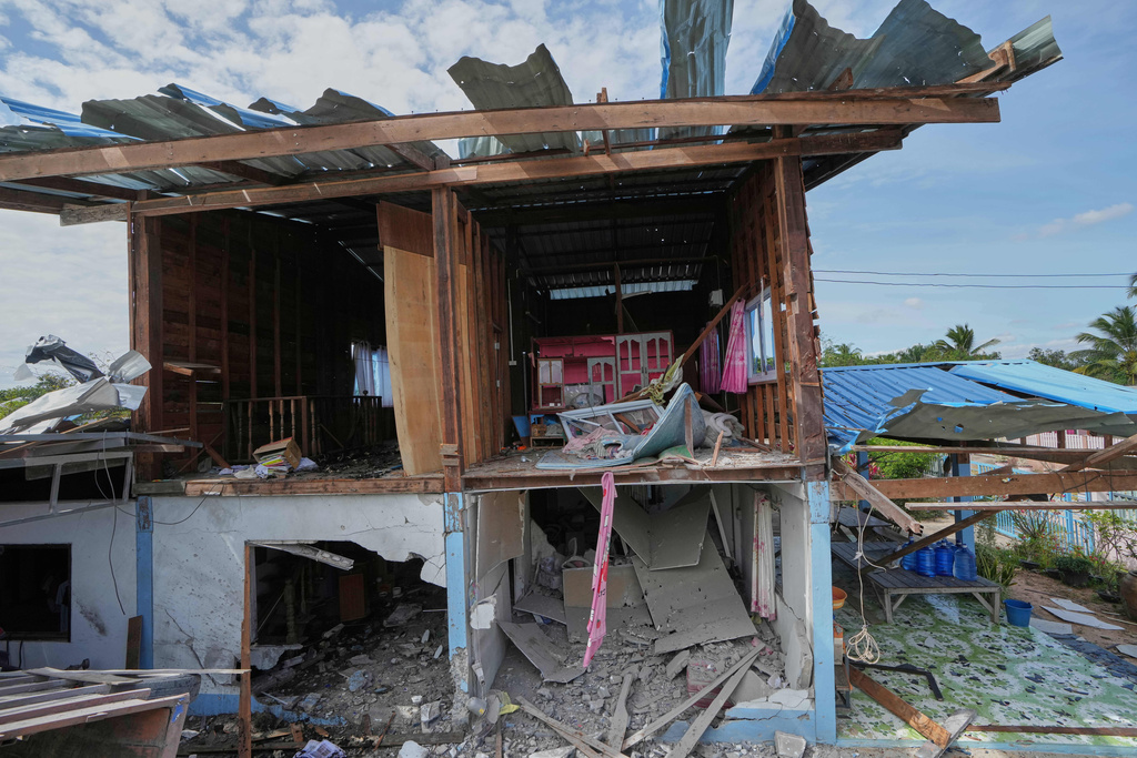 A house is seen damaged following a Thai soldier said was a Cambodian artillery strike in Sisaket province, Thailand, Sunday, Dec. 14, 2025. (AP Photo/Sakchai Lalit)