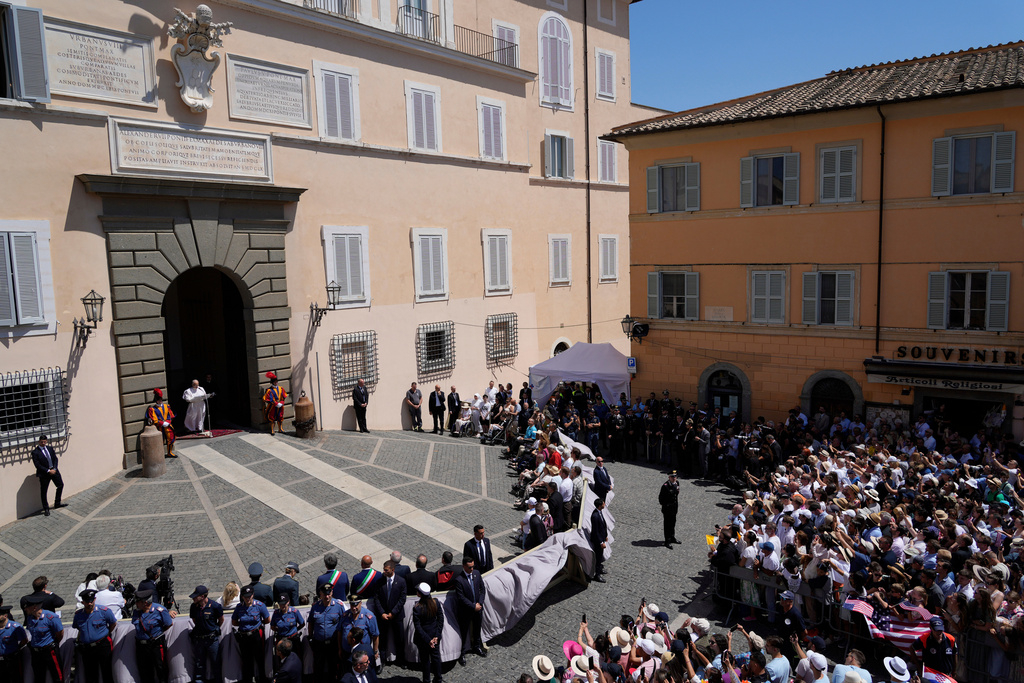 FILE - Pope Leo XIV blesses the faithful gathered in the square in front of the Apostolic Palace for the noon Angelus prayer in Castel Gandolfo, Italy, July 20, 2025. (AP Photo/Gregorio Borgia, File)