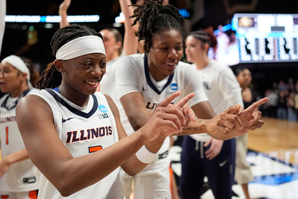 Illinois guard Destiny Jackson, left, and forward Naomi Benson, right celebrate after the team's win in the first round of the NCAA college basketball tournament against Colorado, Saturday, March 21, 2026, in Nashville, Tenn. (AP Photo/George Walker IV)