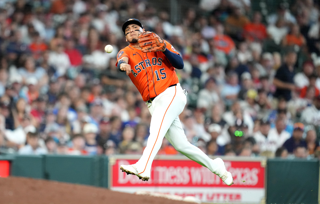 Houston Astros third baseman Isaac Paredes tries to make a throw to first base as Atlanta Braves' Ronald Acuna Jr. singled during the fifth inning of a baseball game, Sunday, Sept. 20, 2026, in Houston. (AP Photo/Karen Warren)