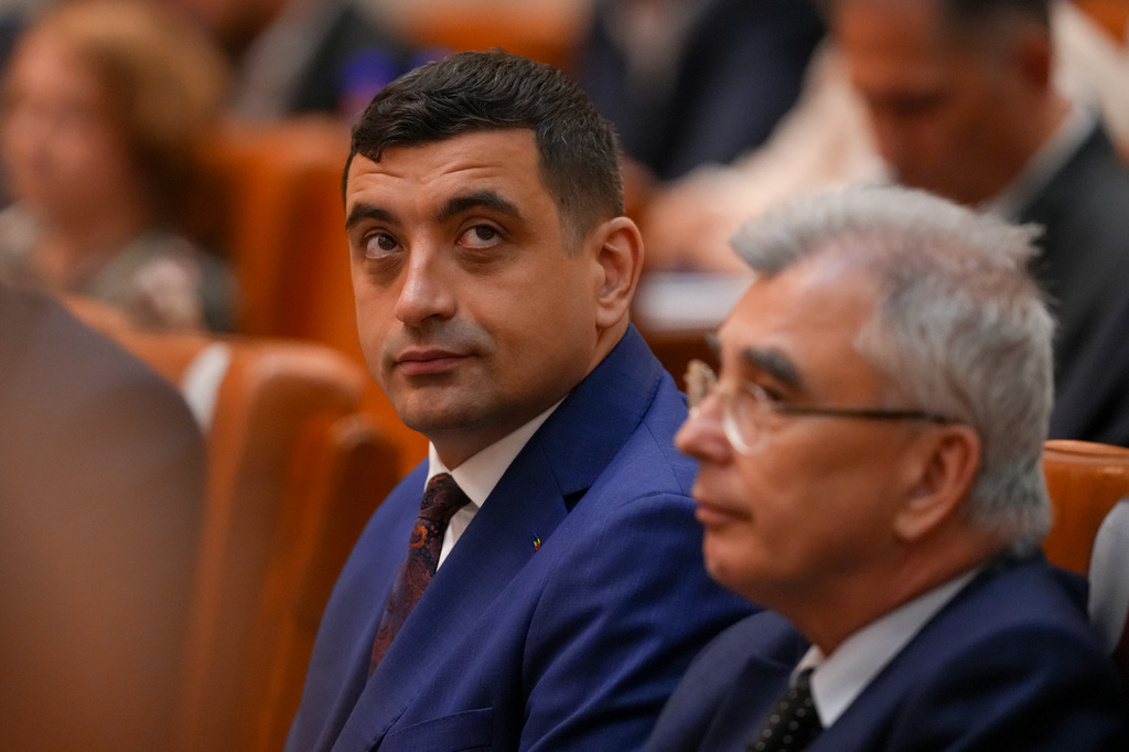George Simion, leader of the opposition right wing AUR alliance attends a joint parliament session ahead of a vote of confidence for the new government team led by Romanian Prime Minister designate Adrian Vestea, in Bucharest, Romania, Monday, June 22, 2026. (AP Photo/Vadim Ghirda)