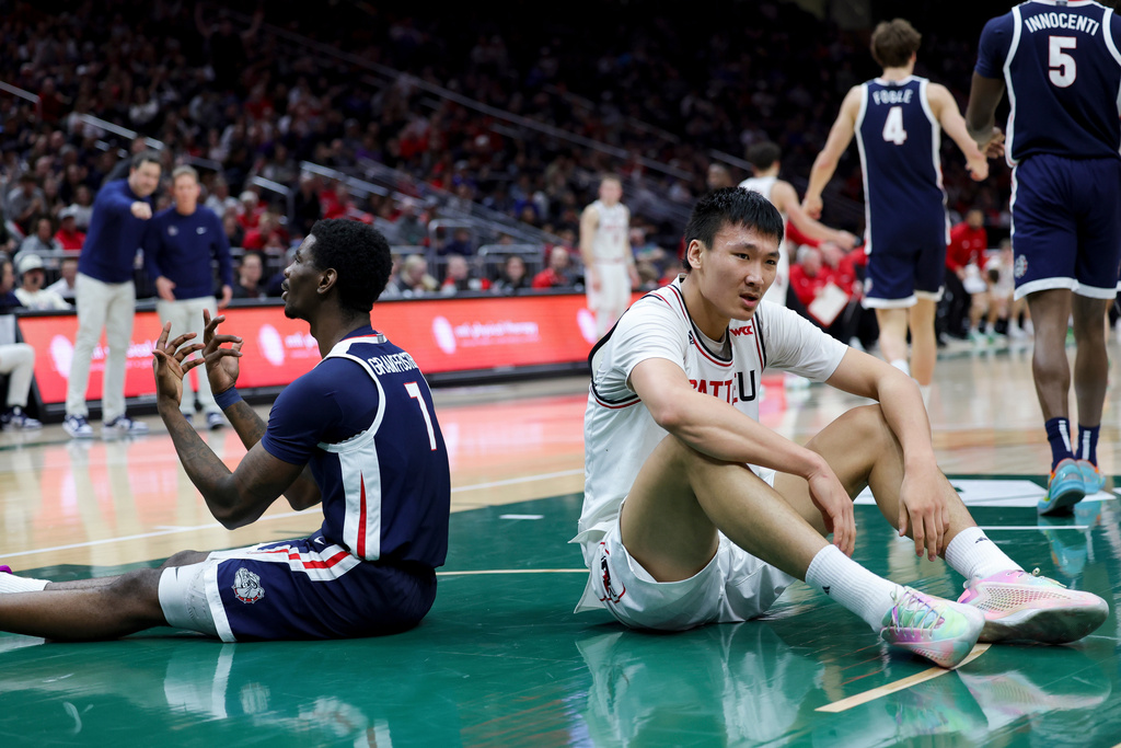 Seattle University center Houran Dan, right, and Gonzaga guard Tyon Grant-Foster react while on the floor during the second half of an NCAA college basketball game Saturday, Jan. 17, 2026, in Seattle. (AP Photo/Ryan Sun)
