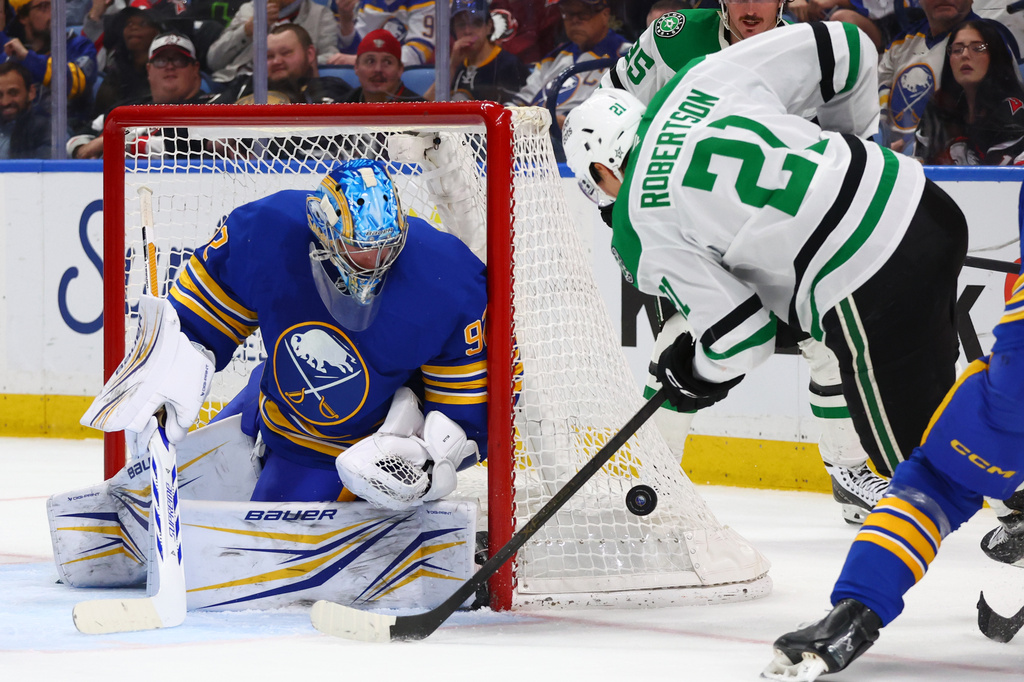 Buffalo Sabres goaltender Colten Ellis (92) stops a shot by Dallas Stars left wing Jason Robertson (21) during the second period of an NHL hockey game Wednesday, April 15, 2026, in Buffalo, N.Y. (AP Photo/Jeffrey T. Barnes)