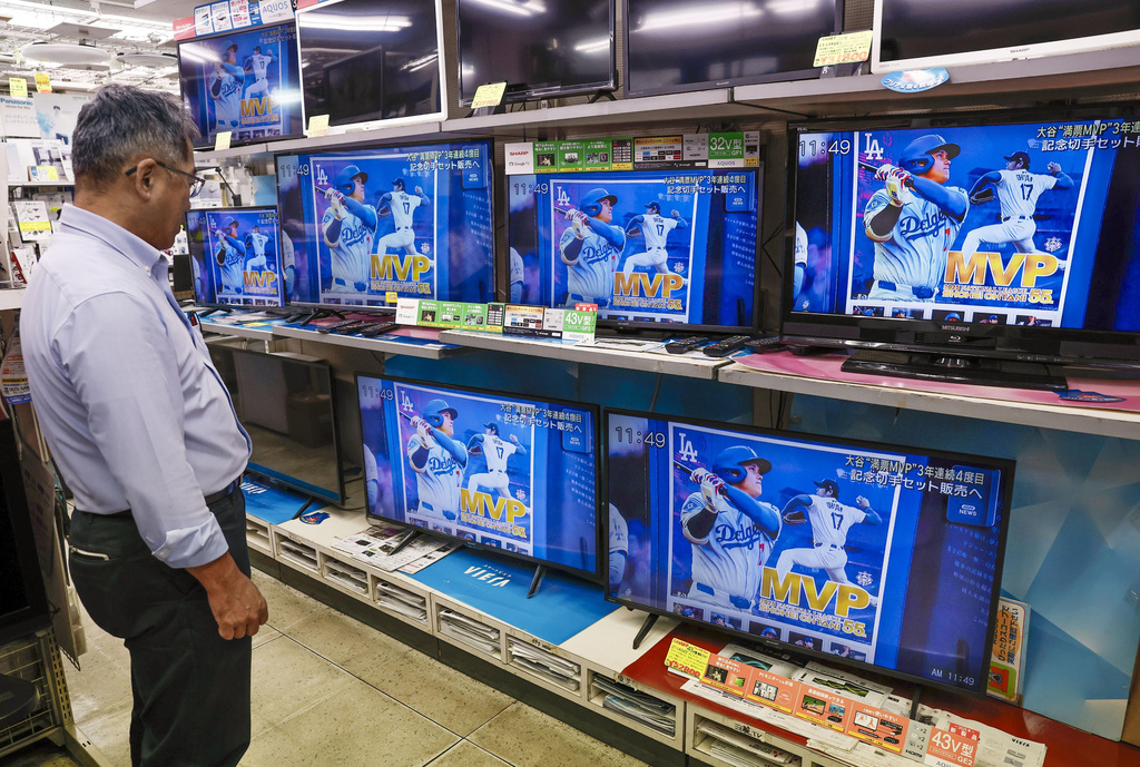 TV screens show the Los Angeles Dodgers Shohei Ohtani, who won a Most Valuable Player award, in a news report, at an electronics store in Osaka, Friday, Nov. 14, 2025. (Kyodo News via AP)