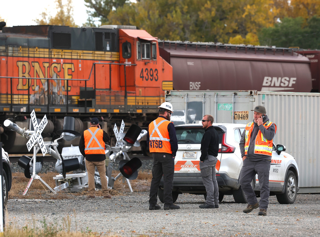 Investigators from the National Transportation Safety Board, Columbus police and Stillwater County Sheriff deputies are on the scene of an train-related accident Sunday, Oct. 19, 2025, in Columbus, MT. (Larry Mayer/The Billings Gazette via AP)