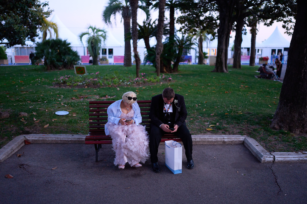 Festivalgoers wait in a park near the 79th international film festival, Cannes, southern France, Wednesday, May 13, 2026. (AP Photo/John Locher)