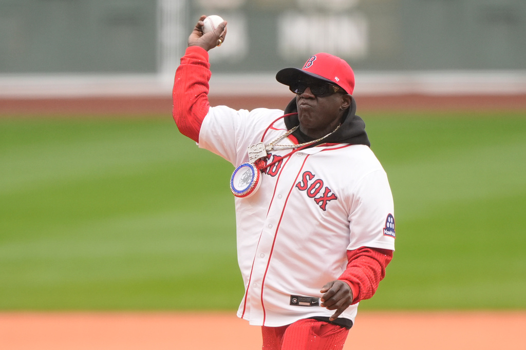 Rapper Flavor Flav throws out the first pitch before a baseball game between the Boston Red Sox and the San Diego Padres, Sunday, April 5, 2026, in Boston. (AP Photo/Robert F. Bukaty)