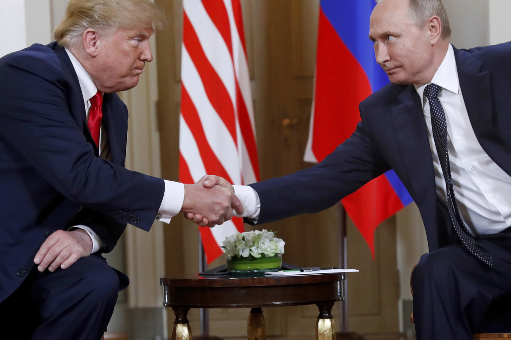 FILE - President Donald Trump, left, and Russian President Vladimir Putin shake hands at the beginning of a meeting at the Presidential Palace in Helsinki, Finland, July 16, 2018. (AP Photo/Pablo Martinez Monsivais, File)