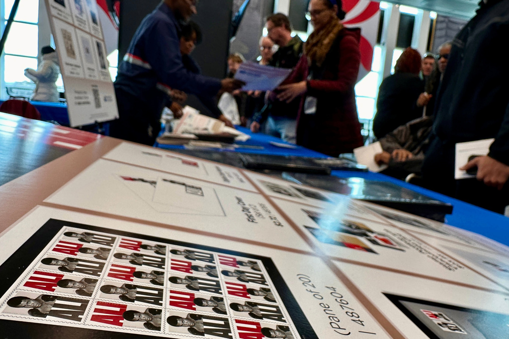 Commemorative stamps featuring boxing legend Muhammad Ali are purchased after the stamp was unveiled by the U.S. Postal Service in Louisville, Ky., on Thursday, Jan. 15, 2026. (AP Photo/Dylan Lovan)