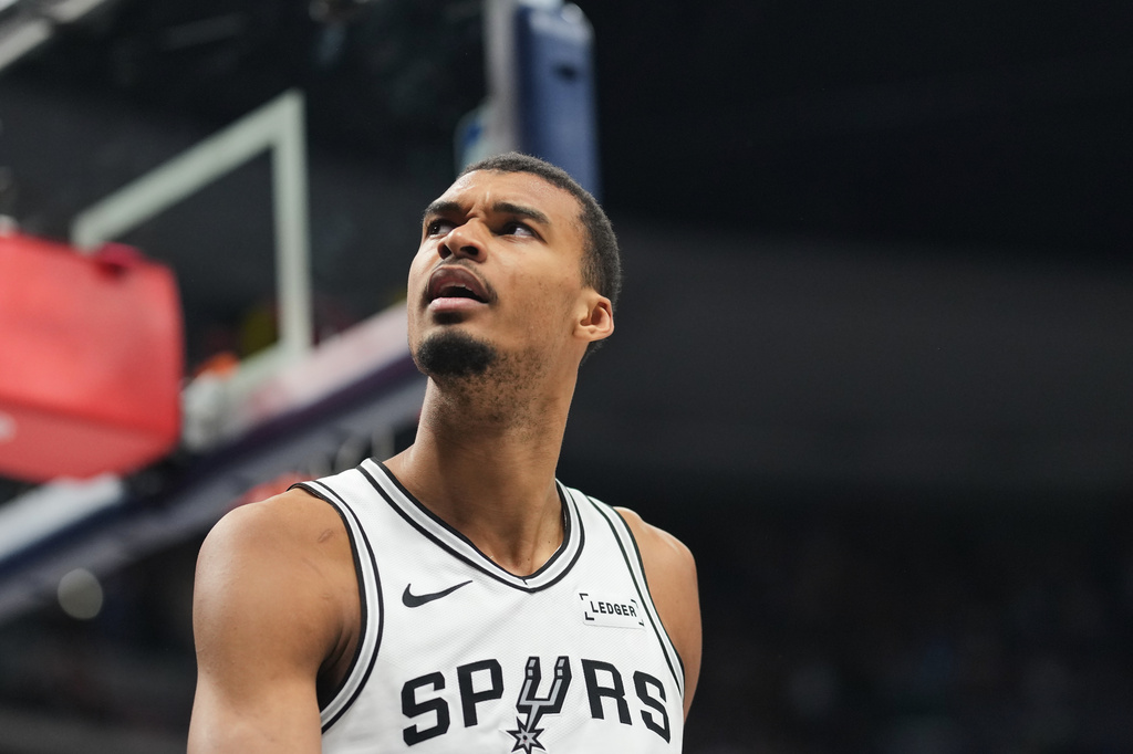 San Antonio Spurs center Victor Wembanyama reacts after being called for a foul late in the second half of an NBA basketball game against the Denver Nuggets, Saturday, April 4, 2026, in Denver. (AP Photo/David Zalubowski)