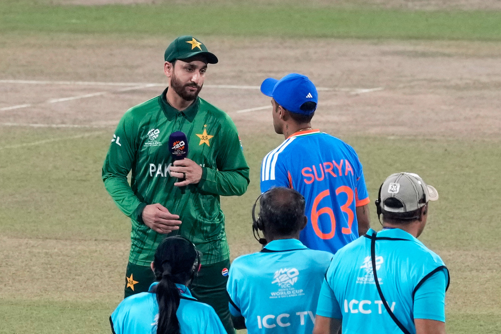 Pakistan's captain Salman Ali Agha, left, looks at India's captain Suryakumar Yadav after the coin toss of the T20 World Cup cricket match between India and Pakistan in Colombo, Sri Lanka, Sunday, Feb. 15, 2026. (AP Photo/Eranga Jayawardena)