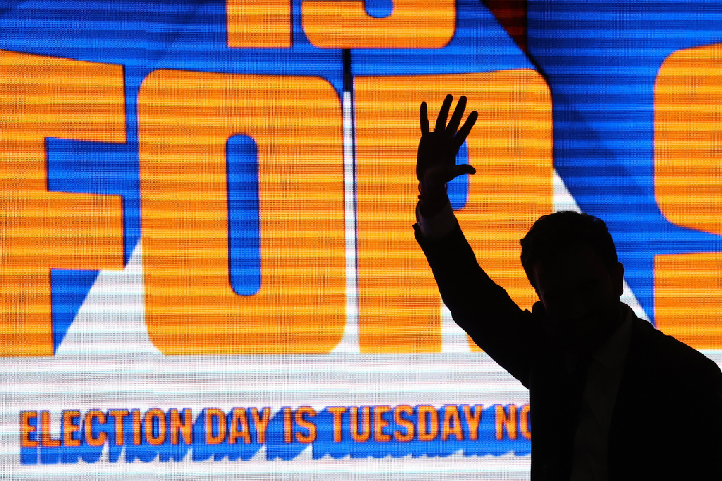 New York City mayoral candidate Zohran Mamdani is silhouetted as he exits the stage after a rally, Sunday, Oct. 26, 2025, in New York. (AP Photo/Heather Khalifa)