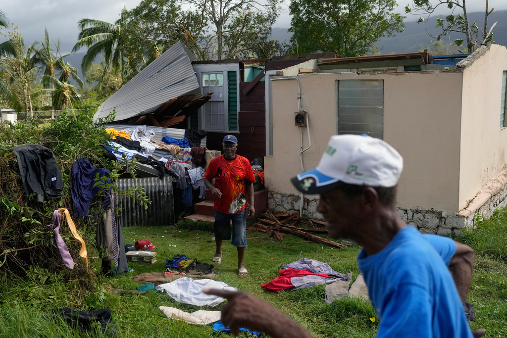 Residents dry belongings at a house damaged by Hurricane Melissa in Santa Cruz, Jamaica, Wednesday, Oct. 29, 2025.(AP Photo/Matias Delacroix)
