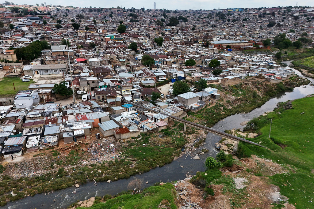 An aerial view of the Jukskei River in the Alexandra township in Johannesburg, South Africa, Wednesday, Nov. 12, 2025. (AP Photo/Nqobile Ntshangase)