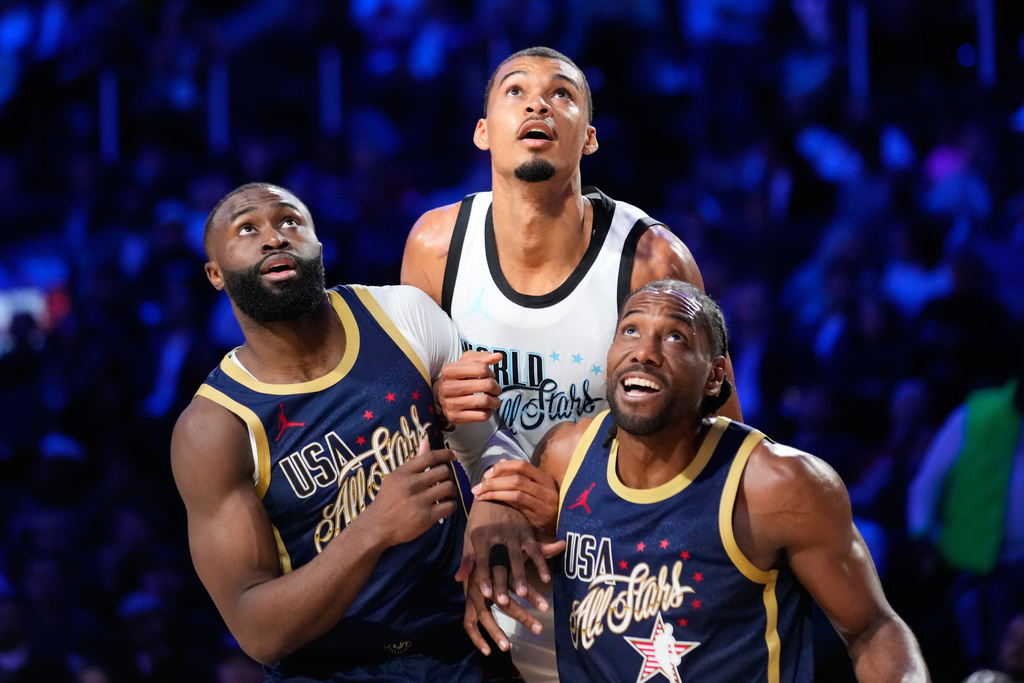 World center Victor Wembanyama, of France, vies for position under the basket next to USA Stripes guard Jaylen Brown, left, and forward Kawhi Leonard during the NBA All-Star basketball game Sunday, Feb. 15, 2026, in Inglewood, Calif. (AP Photo/Mark J. Terrill)