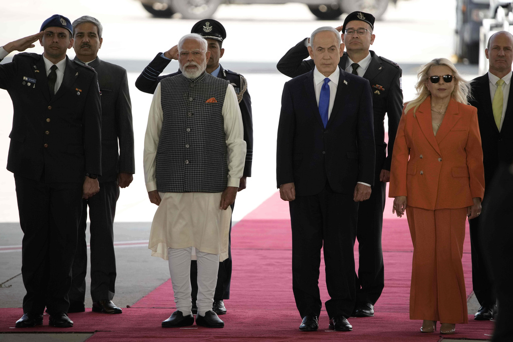 Indian Prime Minister Narendra Modi, centre left, poses next to Israel's Prime Minister Benjamin Netanyahu, centre right, and his wife Sara Netanyahu, foreground right, as he arrives at Ben Gurion Airport near Tel Aviv, Israel, Wednesday, Feb. 25, 2026. (AP Photo/Leo Correa)