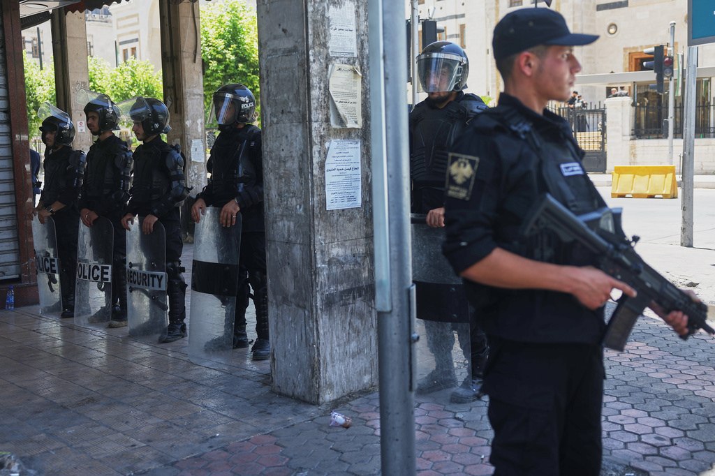 Syrian security forces stand outside before the inaugural session of Syria's newly formed People's Assembly, the first since the fall of President Bashar Assad's government, in Damascus, Syria, Sunday, July 12, 2026. (AP Photo/Ghaith Alsayed)